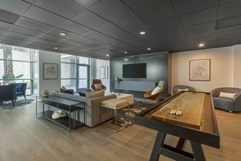 A living room with couches a table and a television